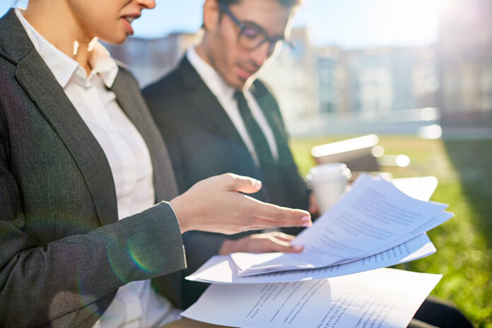 Business people discussing documents at meeting